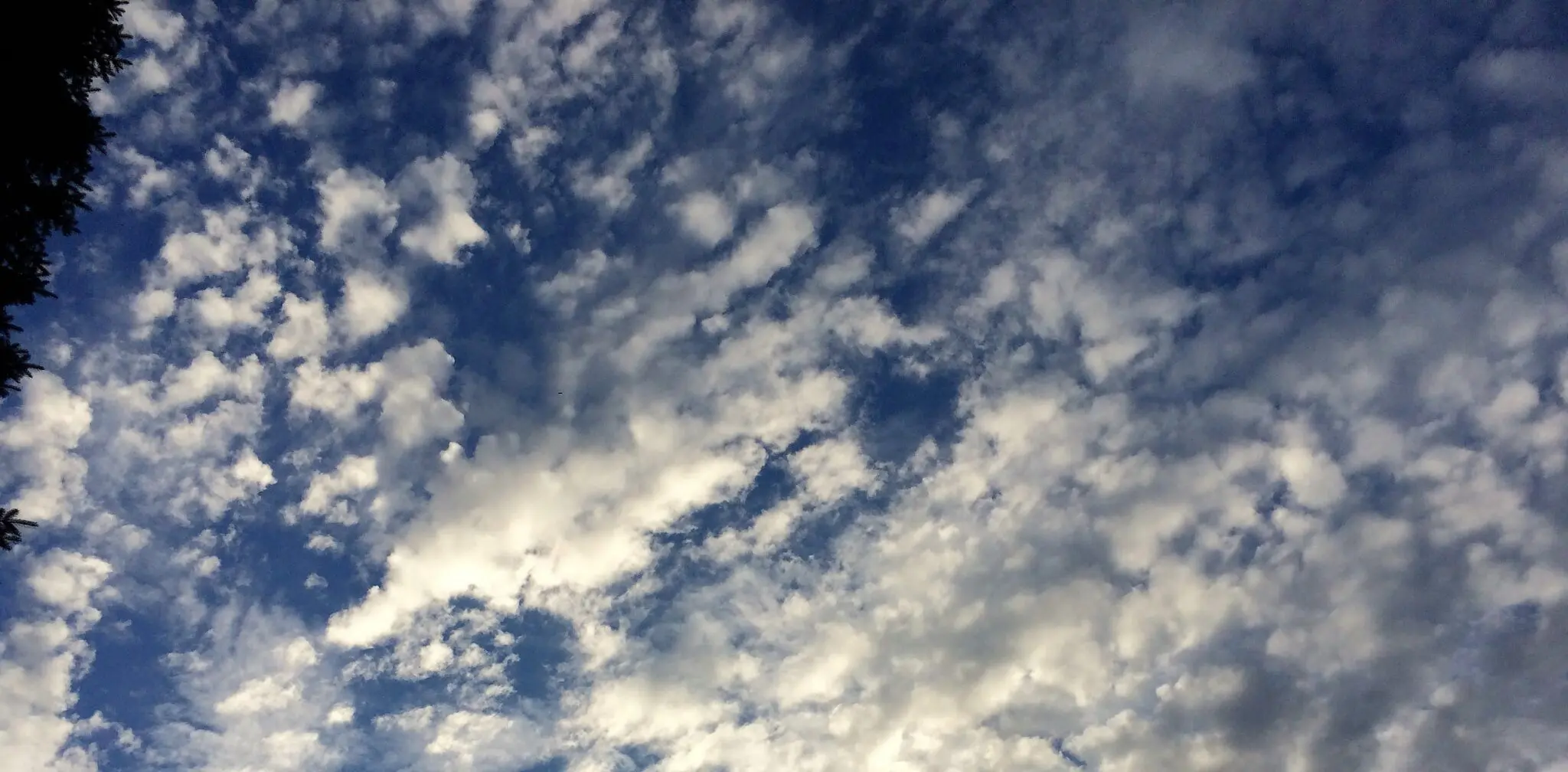 Blue sky with scattered white clouds.
