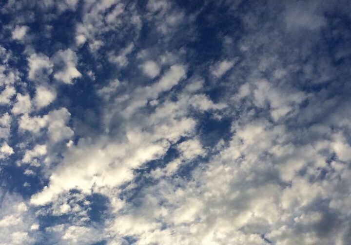 Blue sky with scattered white clouds.