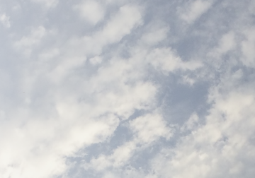 Sky filled with scattered clouds on a bright day.